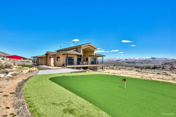 a swimming pool with outdoor seating and yard