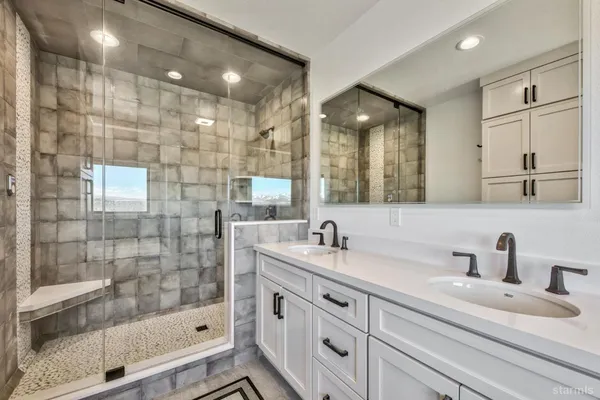 a bathroom with a shower sink and mirror