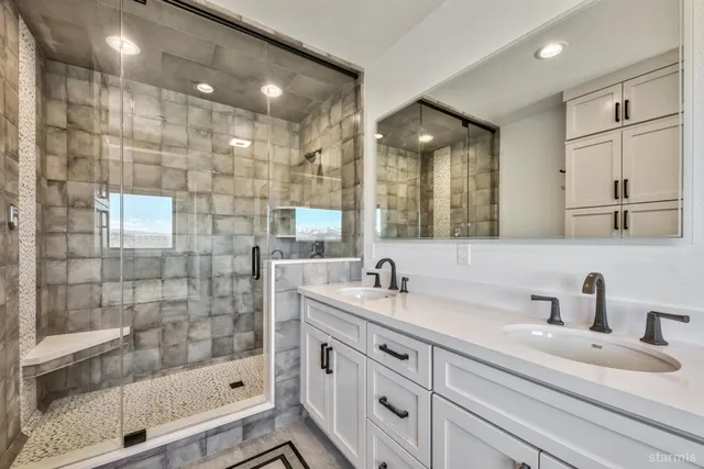 a bathroom with a shower sink and mirror