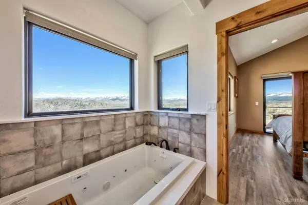 a bathroom with a bathtub and a window