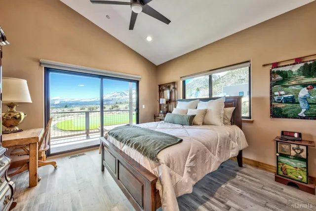 a bed sitting in a spacious bedroom next to a window
