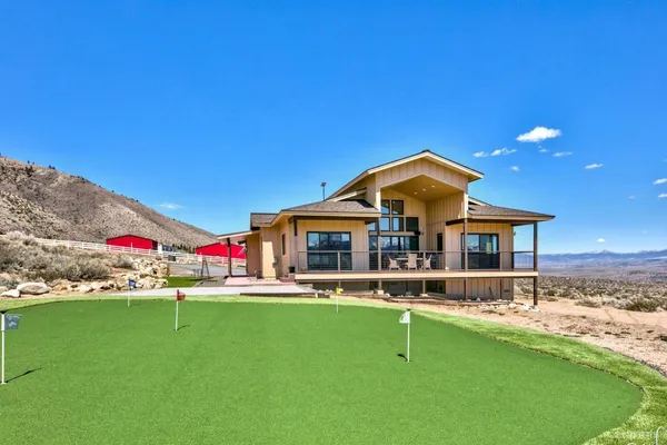 a front view of house with outdoor space and swimming pool