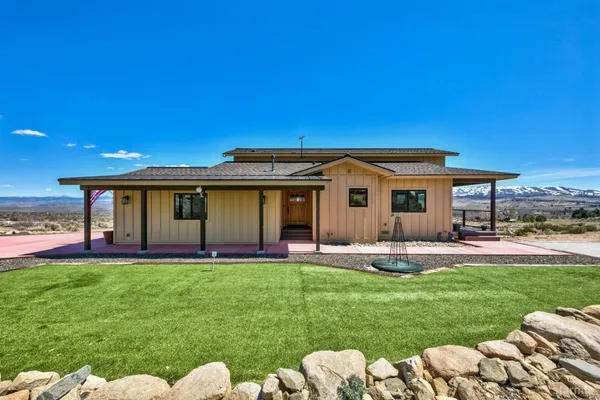 a front view of a house with a yard and porch