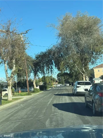 a view of a park with large trees