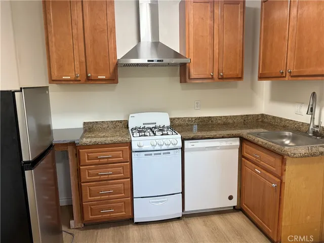 a kitchen with stainless steel appliances granite countertop a stove and a refrigerator