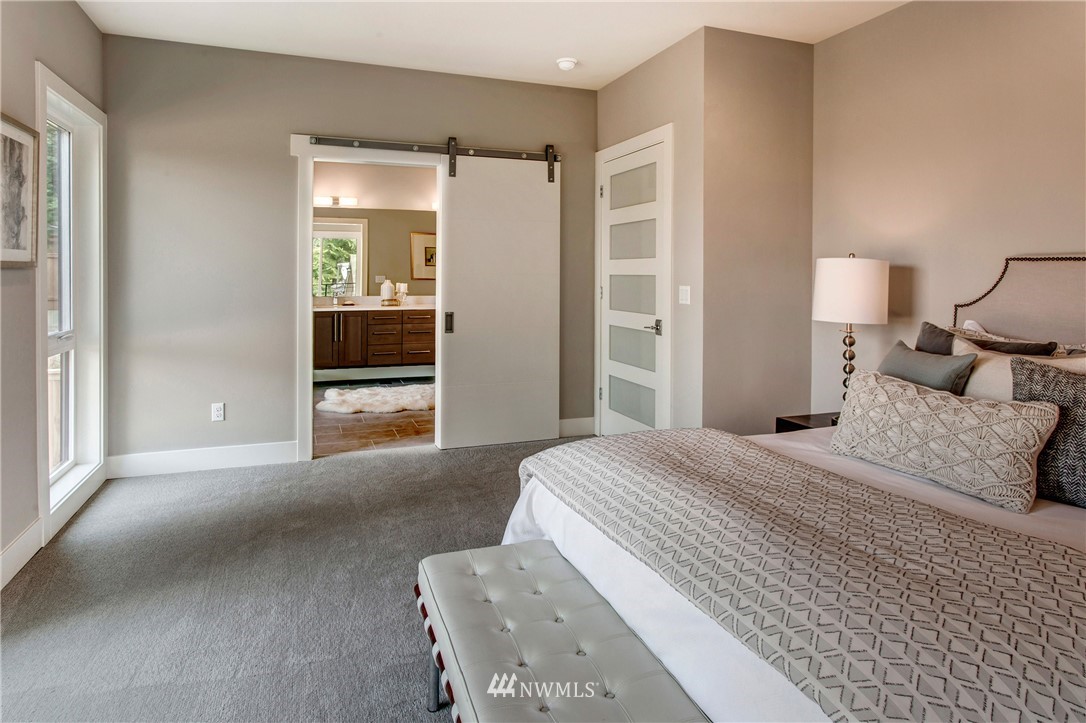 1002 North 30th Street Renton, WA 98056 - Photo 17 of 25 a bedroom with a bed and a large window