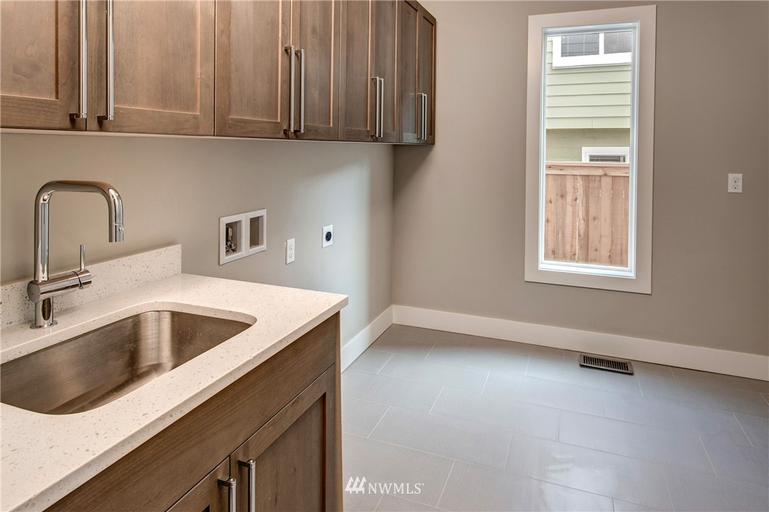 1002 North 30th Street Renton, WA 98056 - Photo 23 of 25 a kitchen with a sink and cabinets