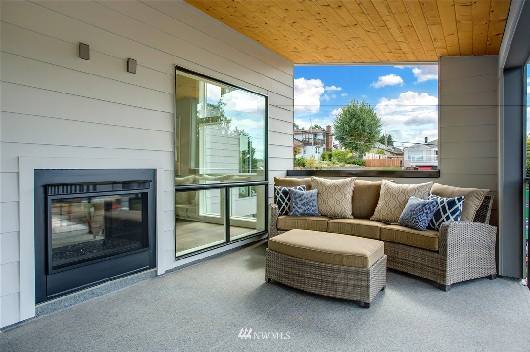 1002 North 30th Street Renton, WA 98056 - Photo 5 of 25 a living room with furniture a large window and a fireplace
