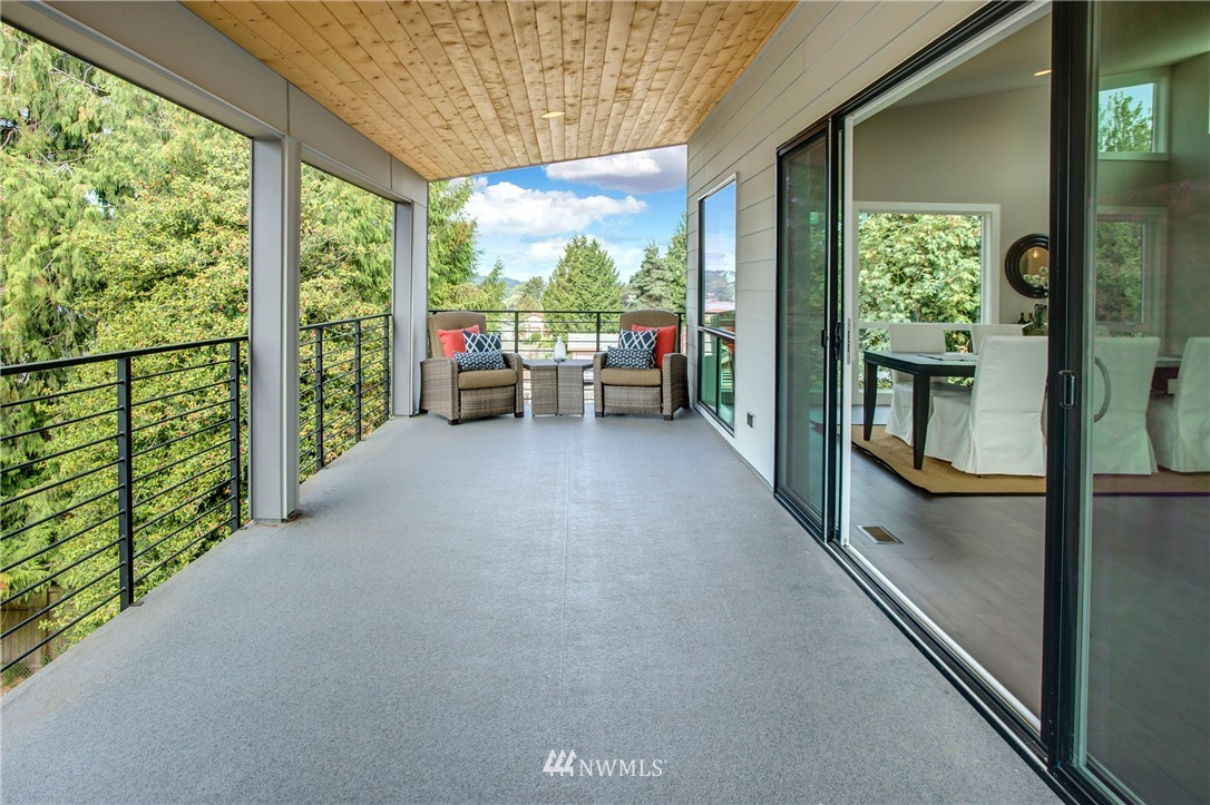 1002 North 30th Street Renton, WA 98056 - Photo 6 of 25 a view of a porch with furniture and floor to ceiling window