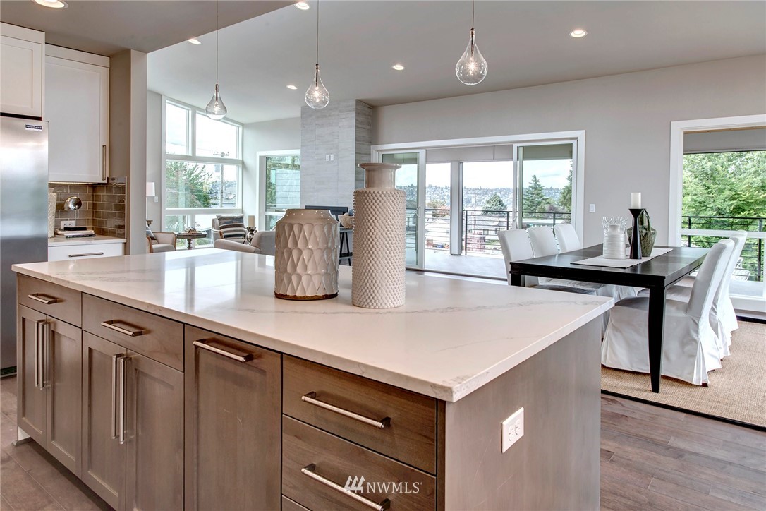 1002 North 30th Street Renton, WA 98056 - Photo 10 of 25 a kitchen with stainless steel appliances granite countertop a sink a stove and a refrigerator