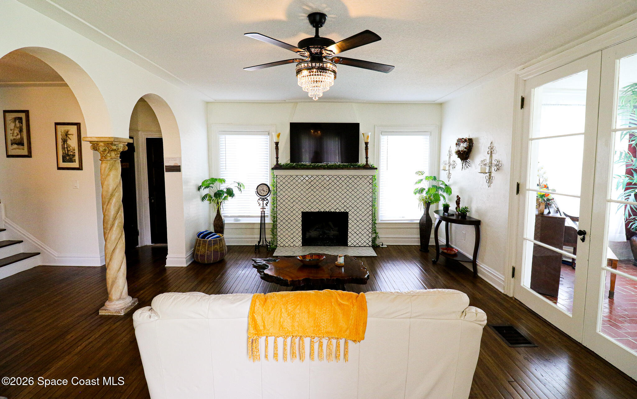 130 Valencia Road Rockledge, FL 32955 - Photo 13 of 72 a living room with furniture potted plant a fireplace and a window