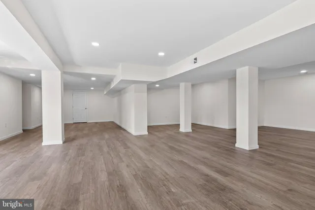 an empty room with wooden floor