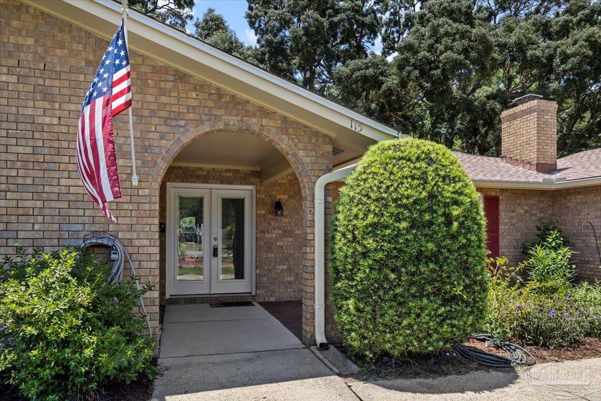 115 Bear Drive Gulf Breeze, FL 32561 - Photo 1 of 40 a front view of a house with garden