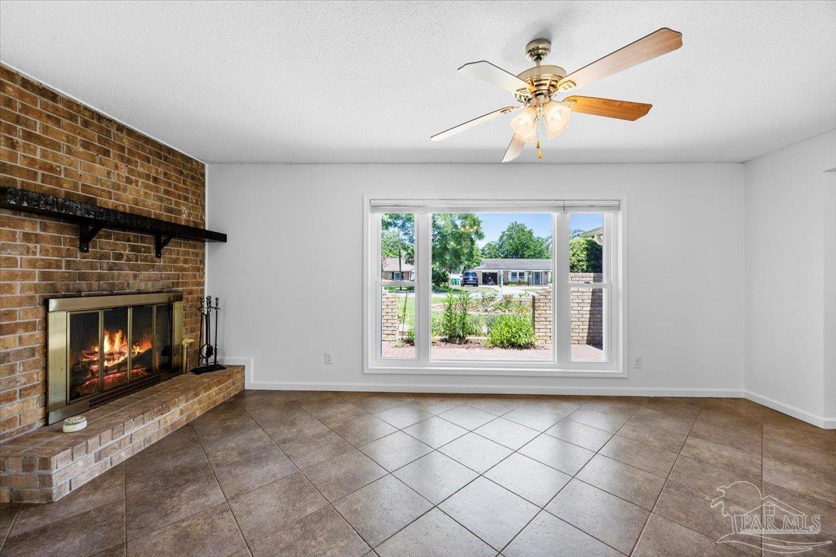 115 Bear Drive Gulf Breeze, FL 32561 - Photo 11 of 40 a view of an empty room with a fireplace