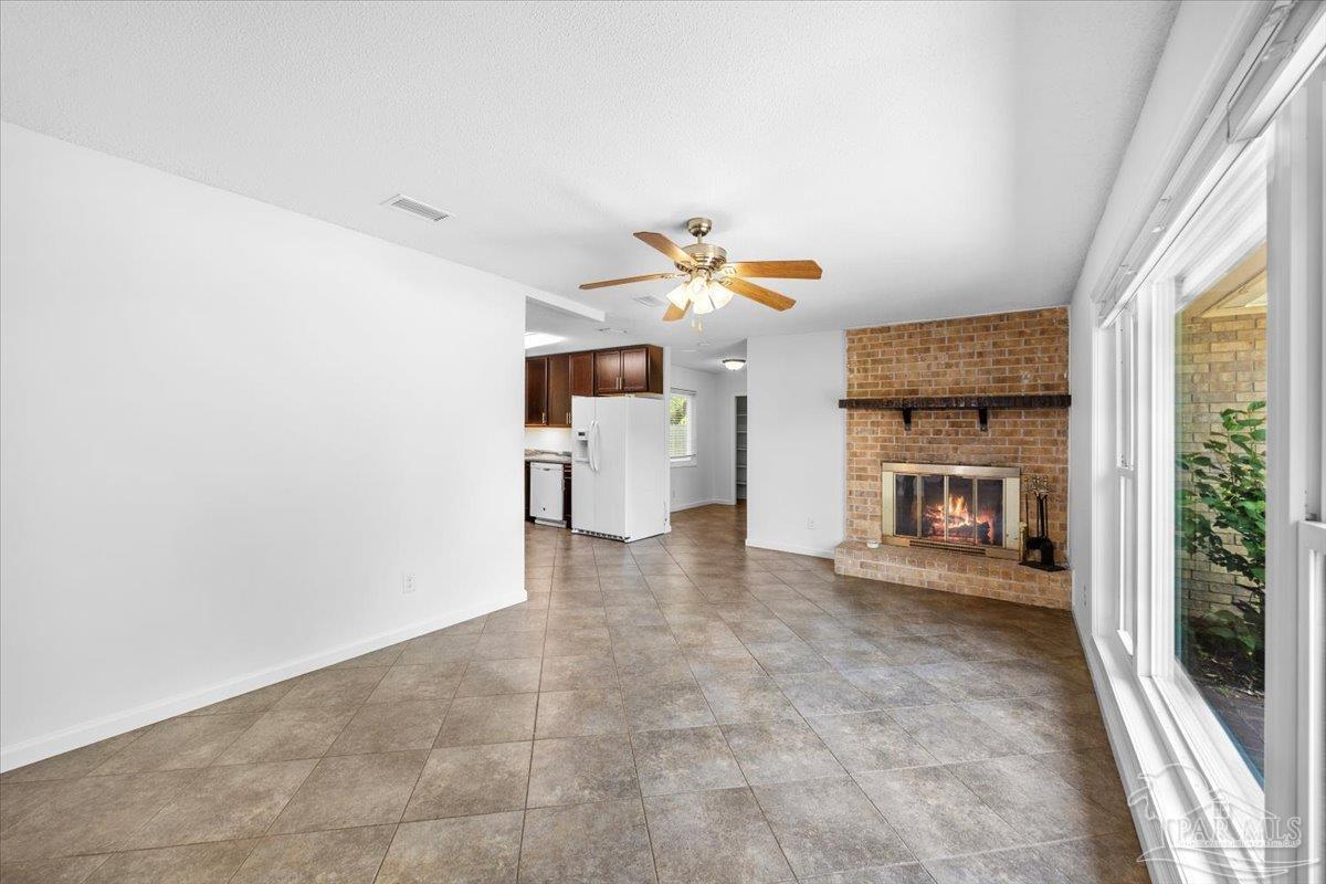 115 Bear Drive Gulf Breeze, FL 32561 - Photo 12 of 40 a view of a kitchen with furniture and a fireplace