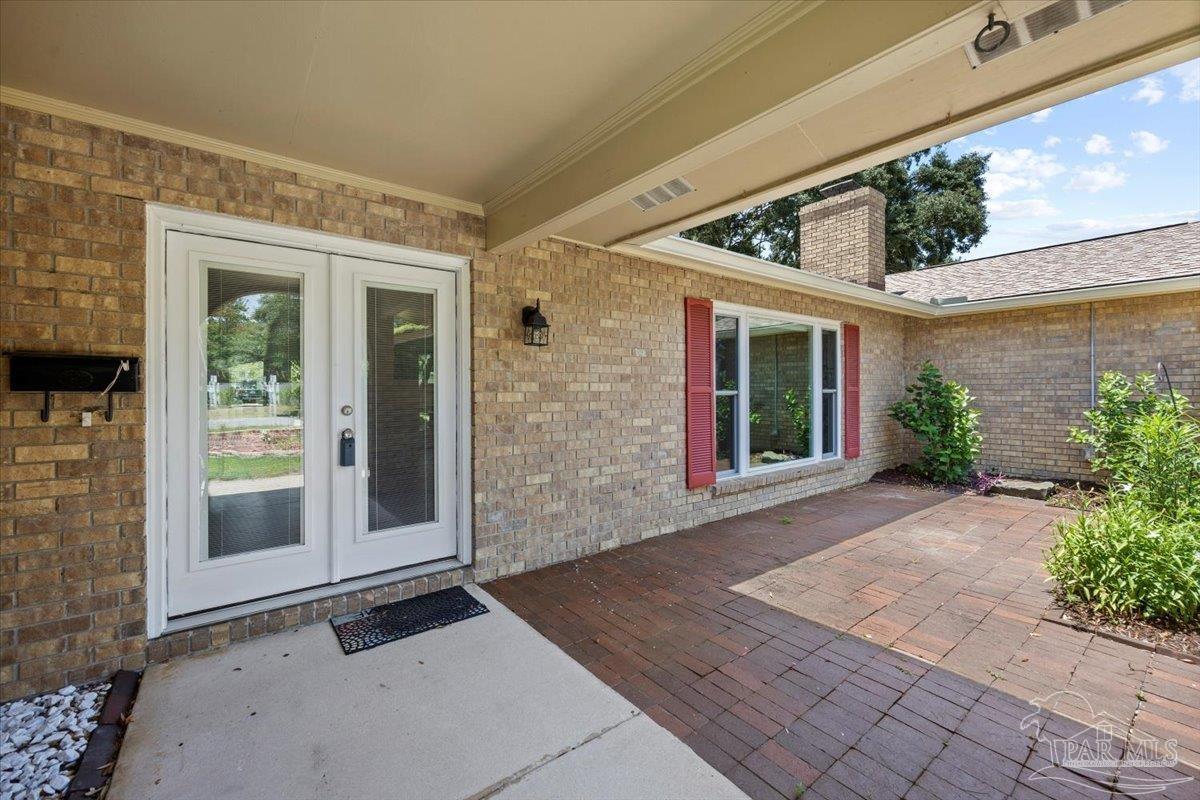 115 Bear Drive Gulf Breeze, FL 32561 - Photo 2 of 40 a view of a brick house with a large window