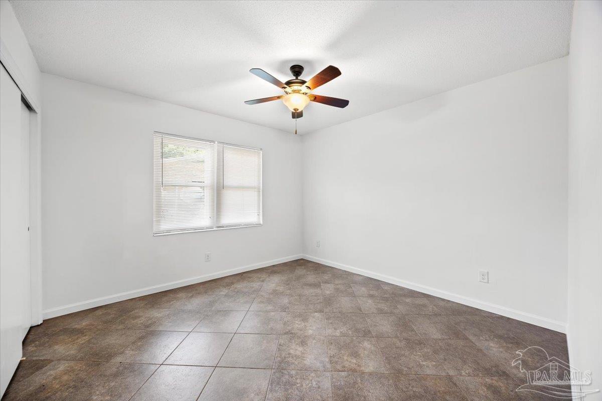115 Bear Drive Gulf Breeze, FL 32561 - Photo 22 of 40 an empty room with windows and fan