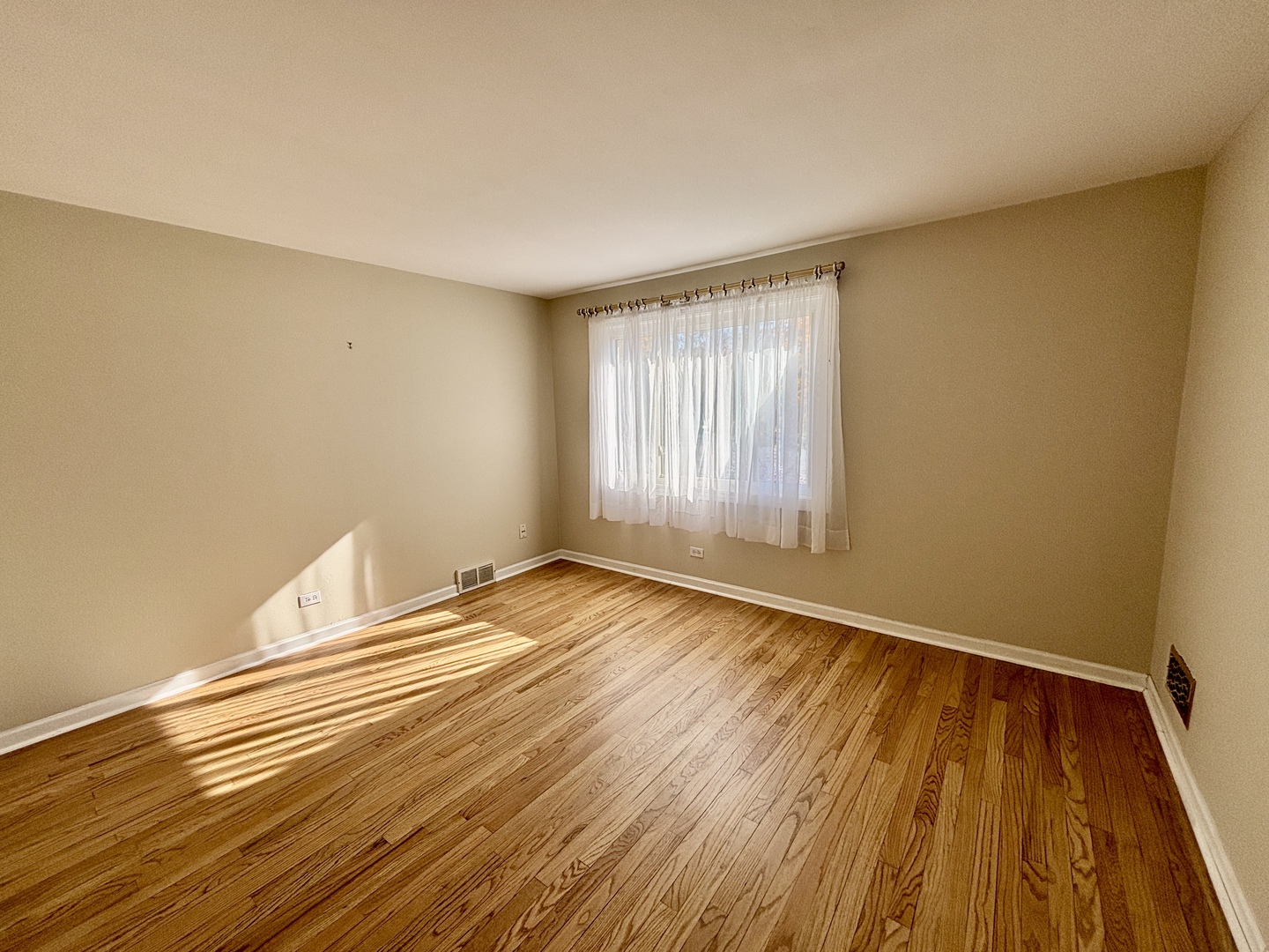 758 Maple Avenue Lisle, IL 60532 - Photo 18 of 31 a view of an empty room with wooden floor and a window