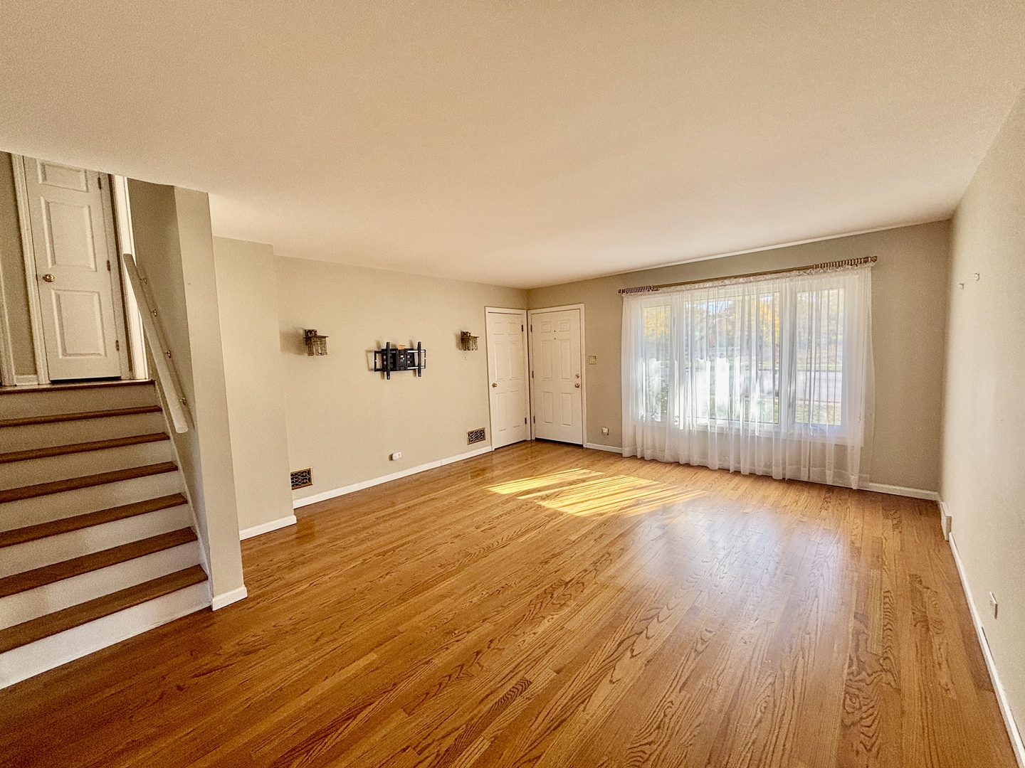 758 Maple Avenue Lisle, IL 60532 - Photo 5 of 31 an empty room with wooden floor and stairs