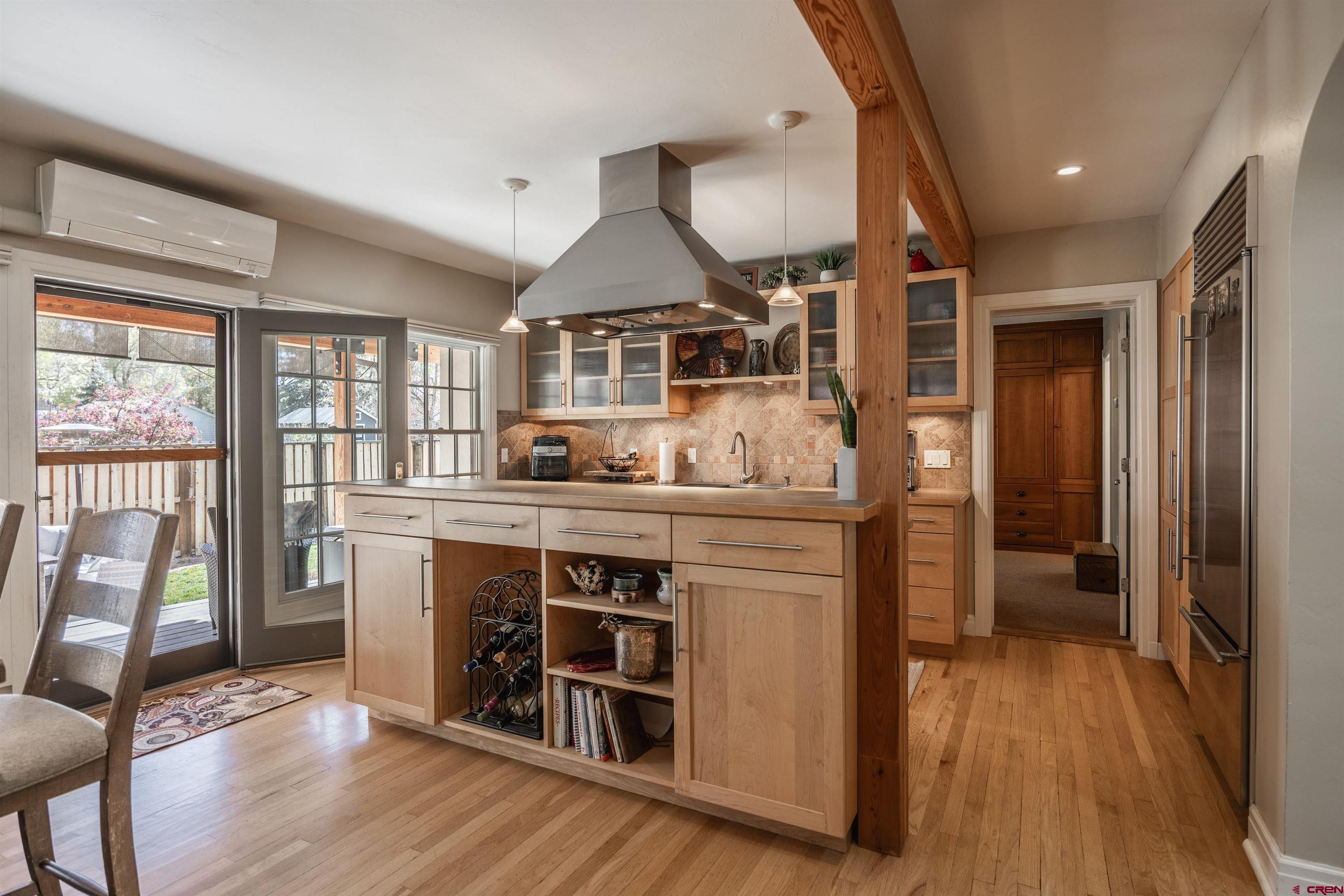 1146 South 2nd Street Montrose, CO 81401 - Photo 13 of 41 a kitchen with stainless steel appliances a stove and wooden floor