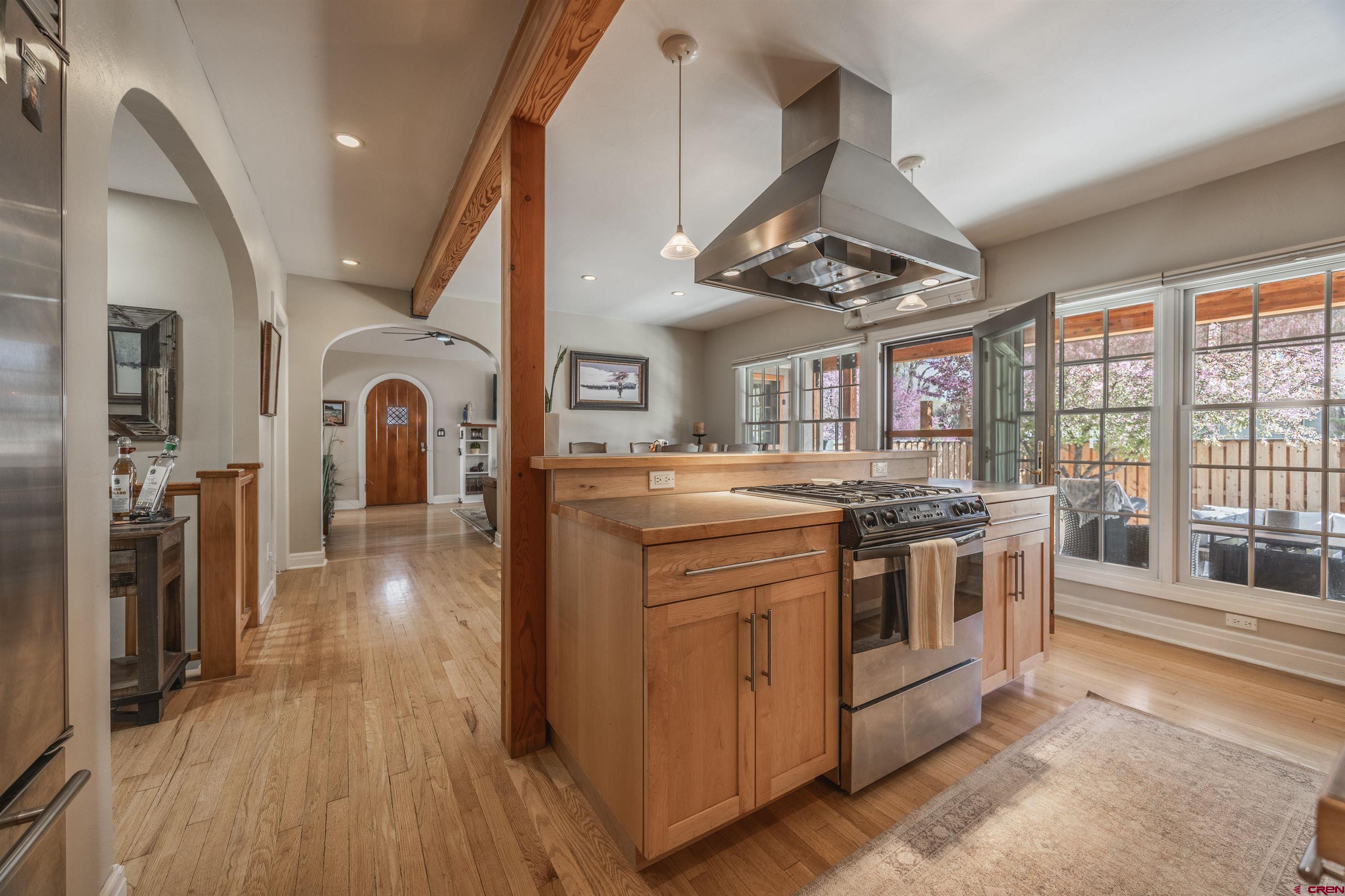 1146 South 2nd Street Montrose, CO 81401 - Photo 16 of 41 a kitchen with stainless steel appliances granite countertop a stove and a wooden floors