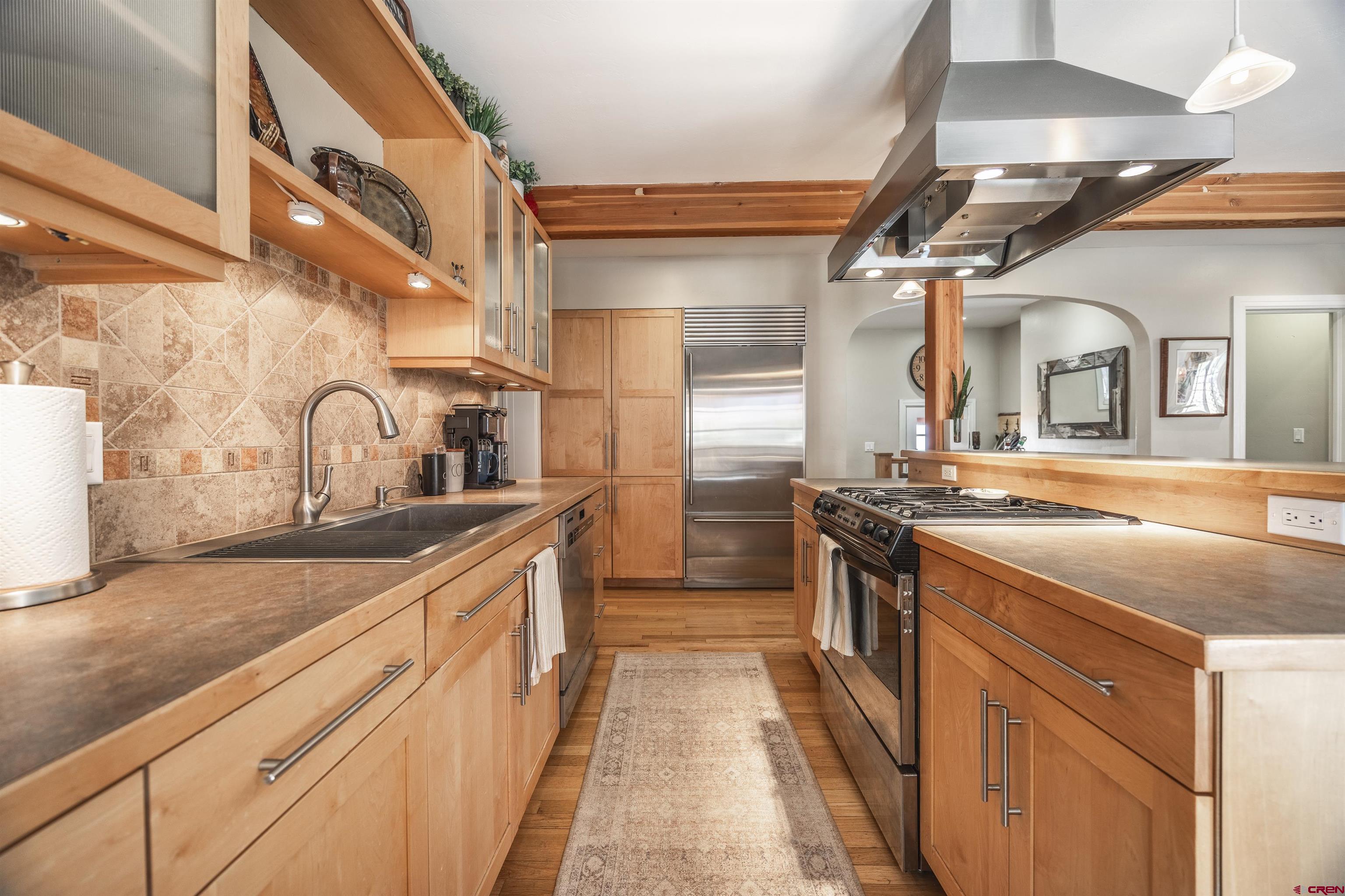 1146 South 2nd Street Montrose, CO 81401 - Photo 17 of 41 a kitchen with stainless steel appliances granite countertop a sink and stove