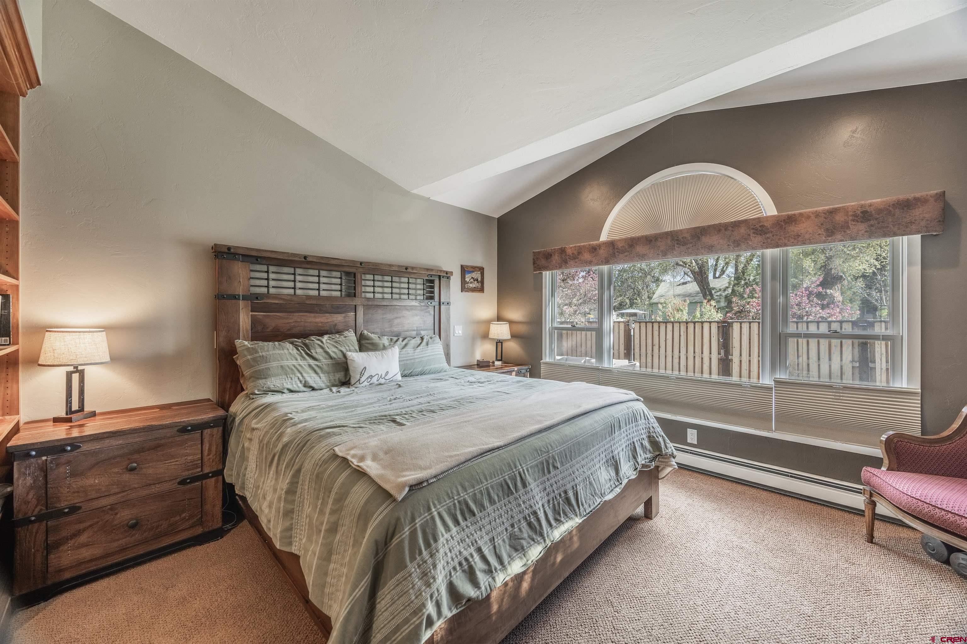 1146 South 2nd Street Montrose, CO 81401 - Photo 22 of 41 a bedroom with a bed and a large window with balcony view