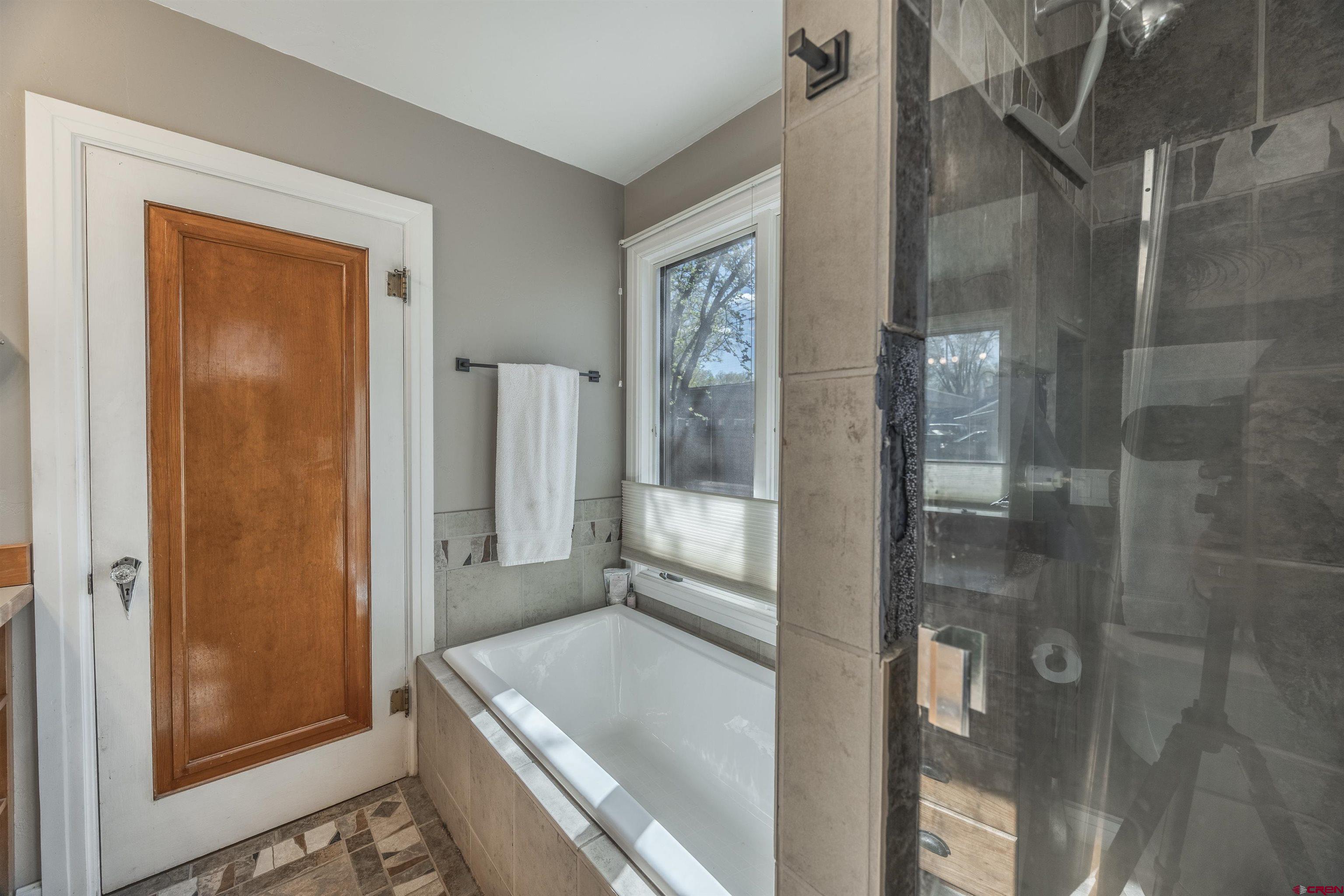 1146 South 2nd Street Montrose, CO 81401 - Photo 25 of 41 a bathroom with a tub and shower