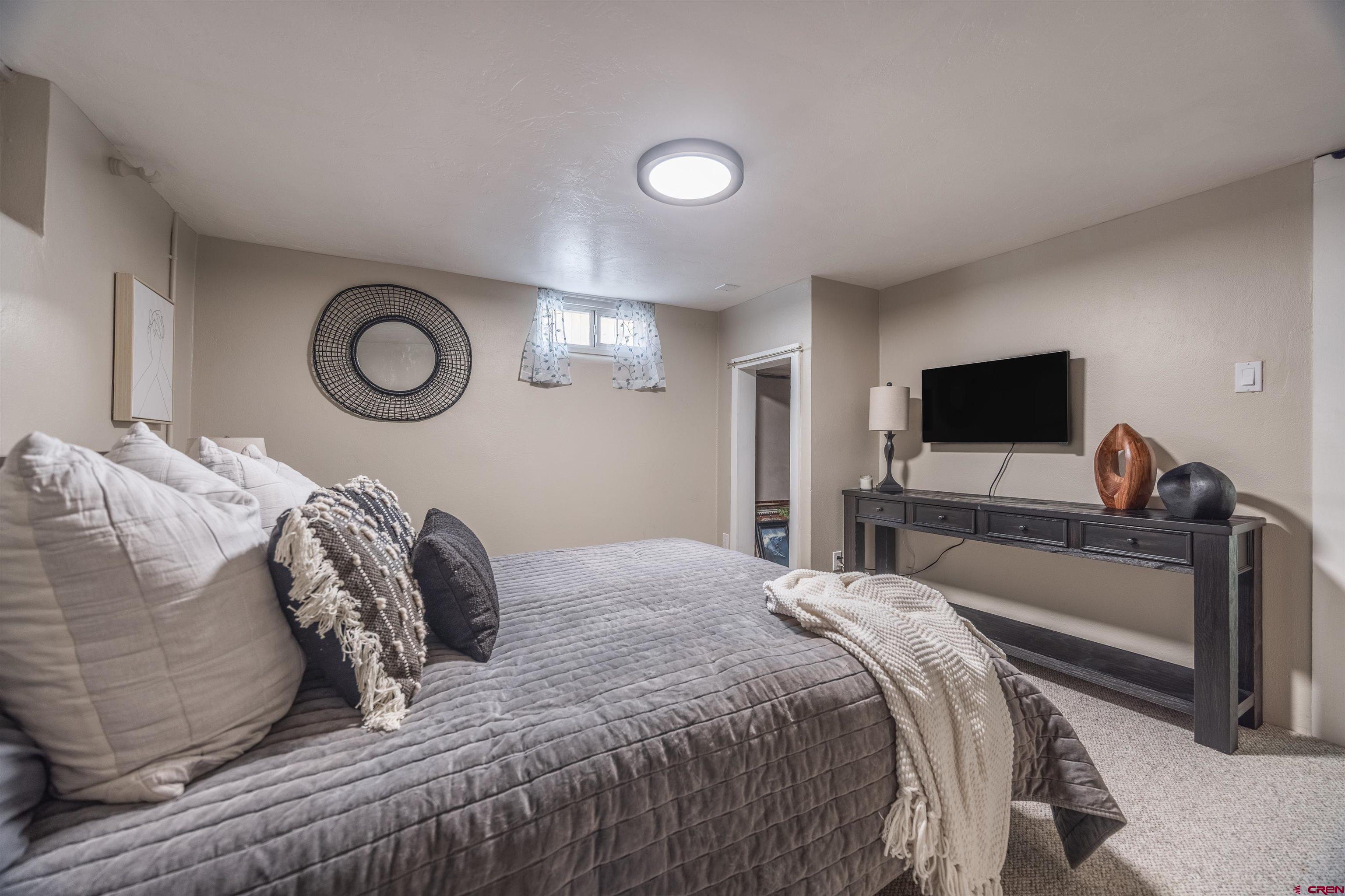 1146 South 2nd Street Montrose, CO 81401 - Photo 27 of 41 a bedroom with a bed and a television