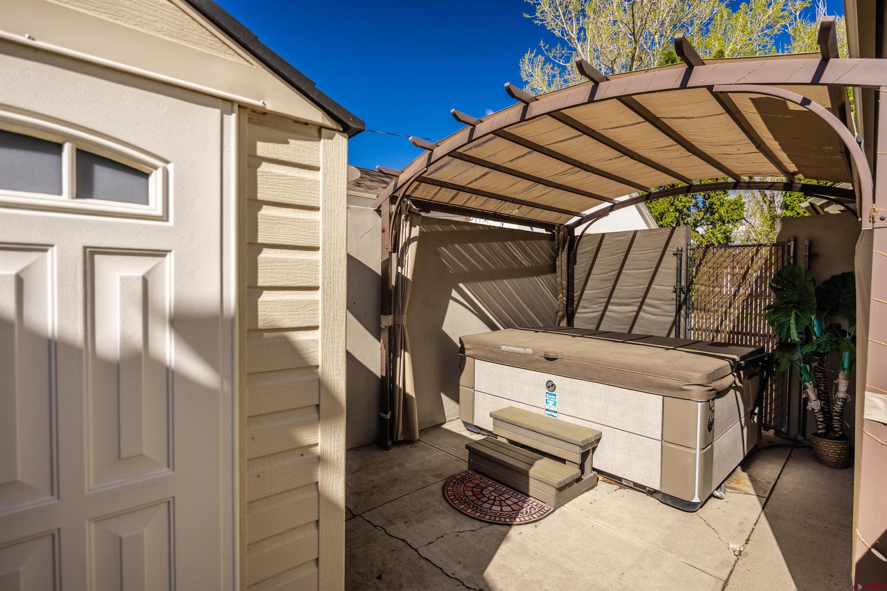 1146 South 2nd Street Montrose, CO 81401 - Photo 37 of 41 a view of a patio with table and chairs under an umbrella
