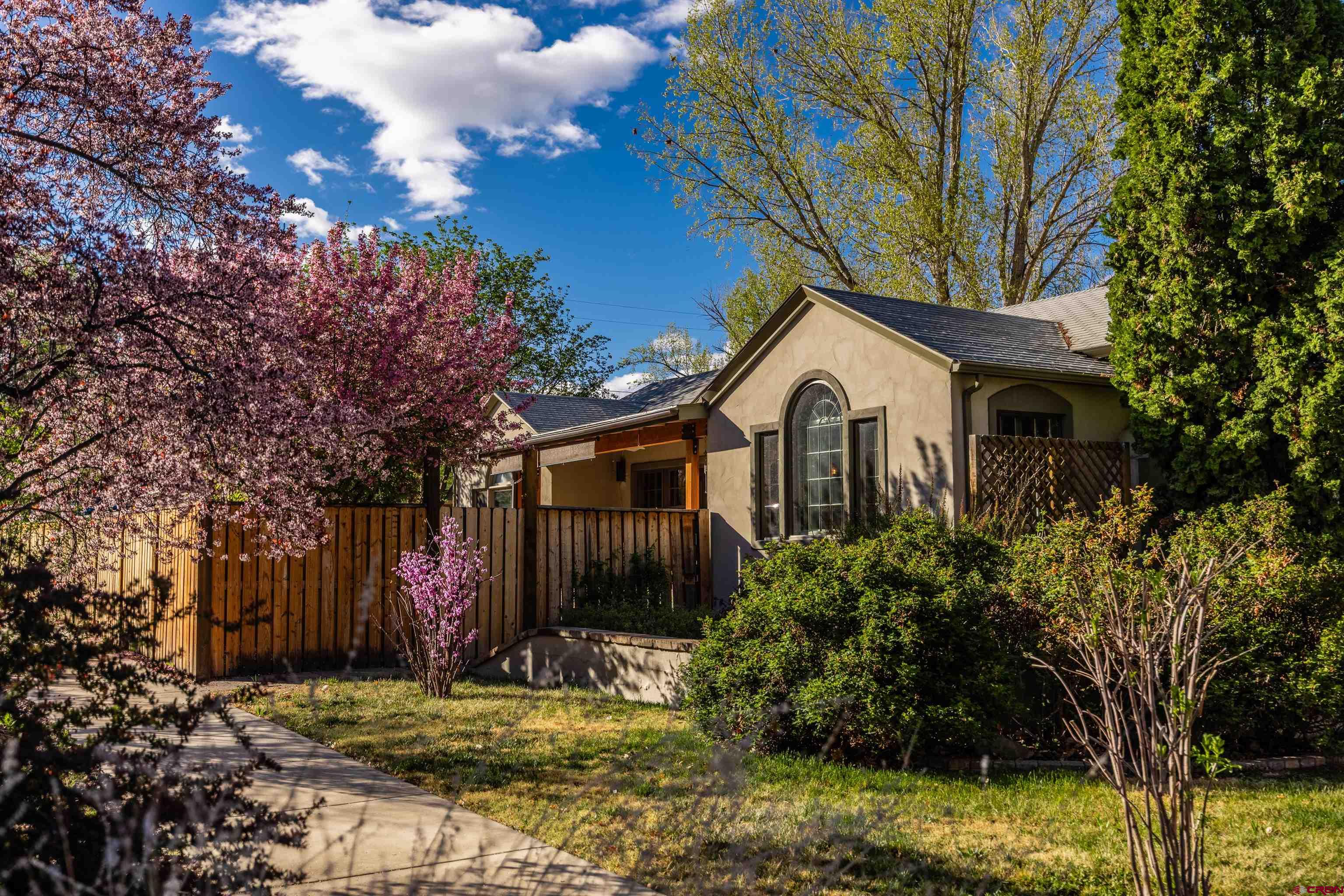 1146 South 2nd Street Montrose, CO 81401 - Photo 4 of 41 a front view of a house with a yard garage and outdoor seating