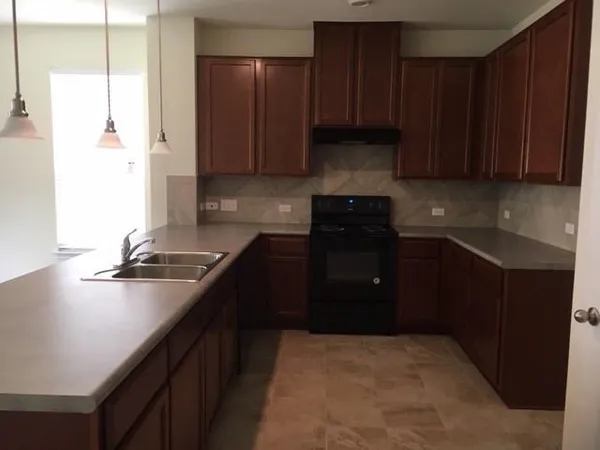 a kitchen with a refrigerator stove and cabinets