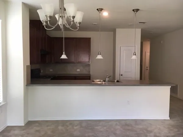 a view of a hallway with a chandelier
