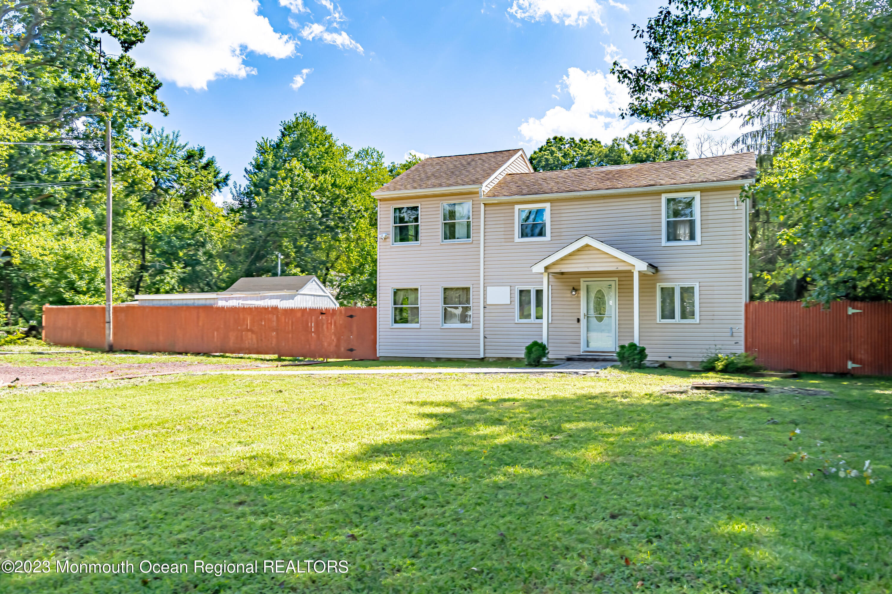 a front view of a house with a garden