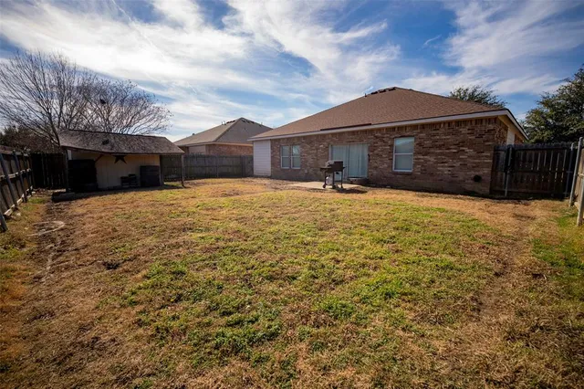 a front view of house with yard and car parked