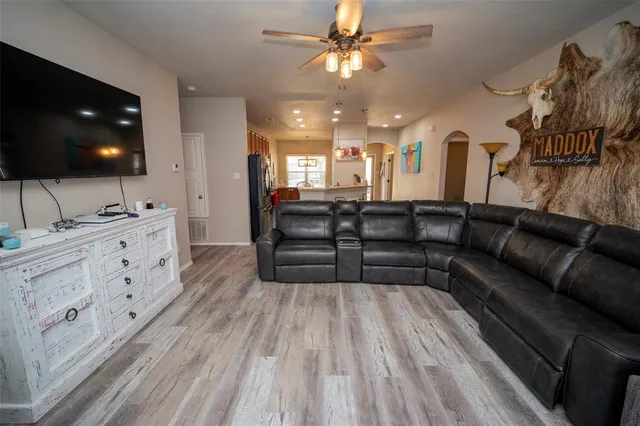 a living room with furniture and a flat screen tv