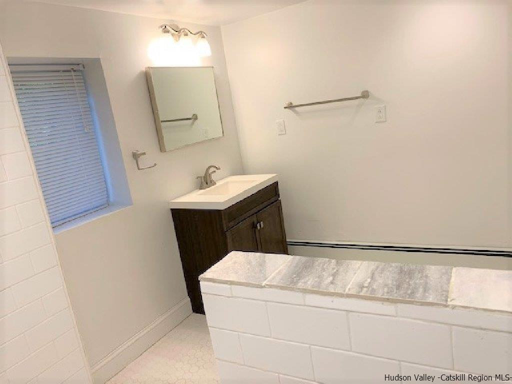 4 Colleen Lane Wallkill, NY 12589 - Photo 9 of 16 a bathroom with a sink and mirror with toilet