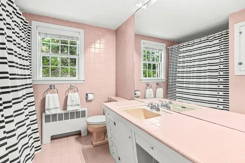 a spacious bedroom with a bed and a large window