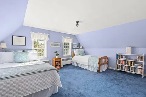 a bedroom with a bed and a television