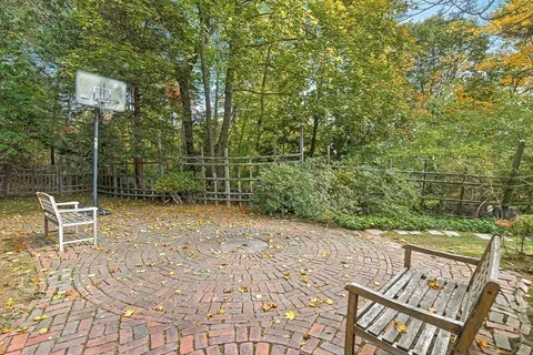 a view of a yard with wooden fence