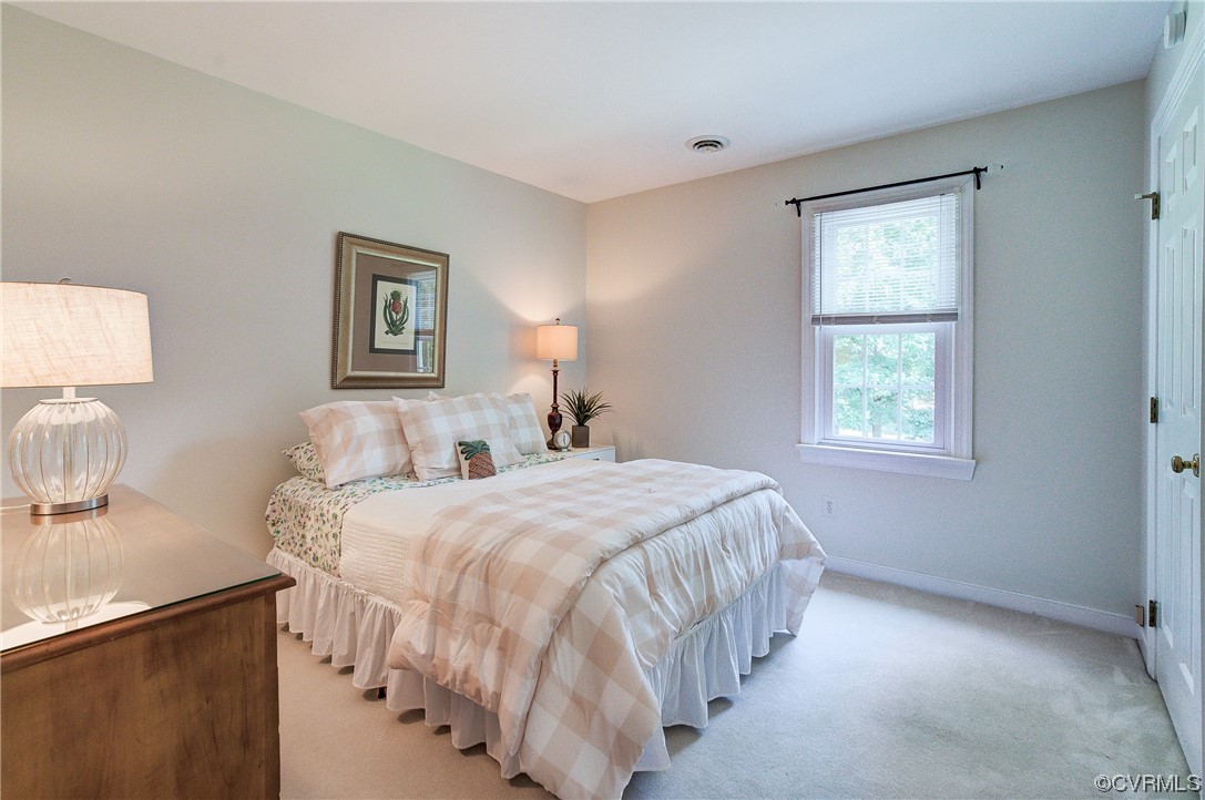 1920 Winterfield Road Midlothian, VA 23113 - Photo 17 of 26 a bedroom with a bed and a lamp on dresser