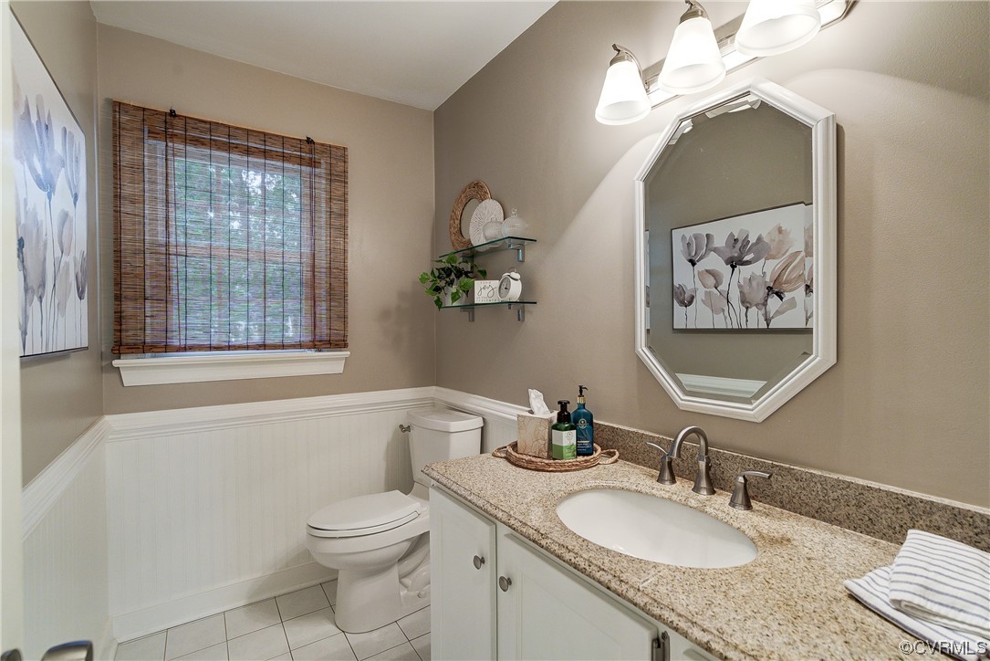 1920 Winterfield Road Midlothian, VA 23113 - Photo 10 of 26 a bathroom with a granite countertop toilet a sink and a mirror