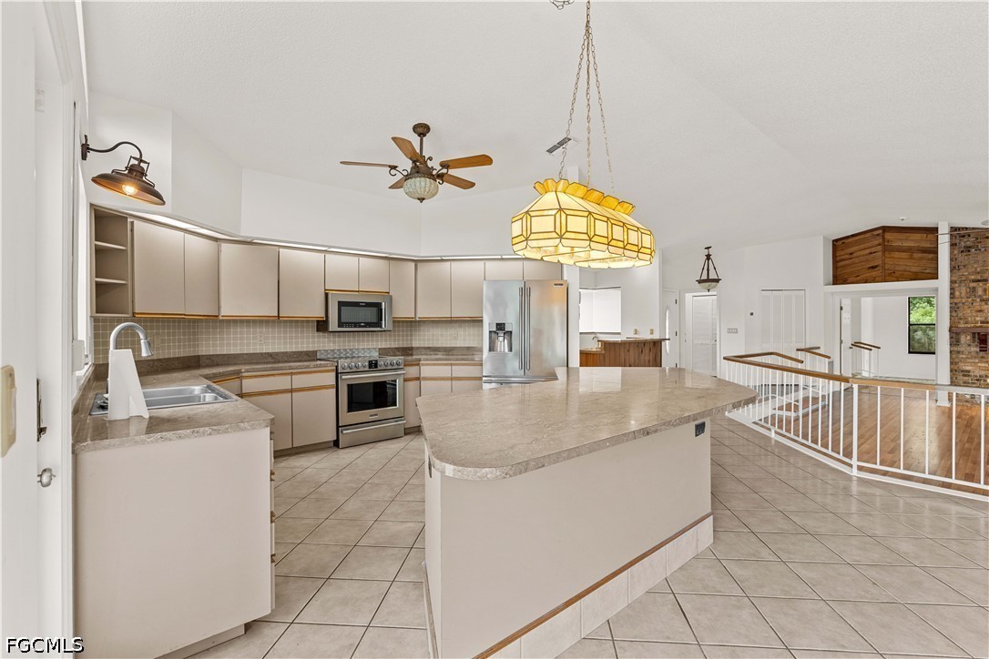 27255 Hickory Hill Road Brooksville, FL 34602 - Photo 23 of 50 a large kitchen with cabinets a sink and a stove