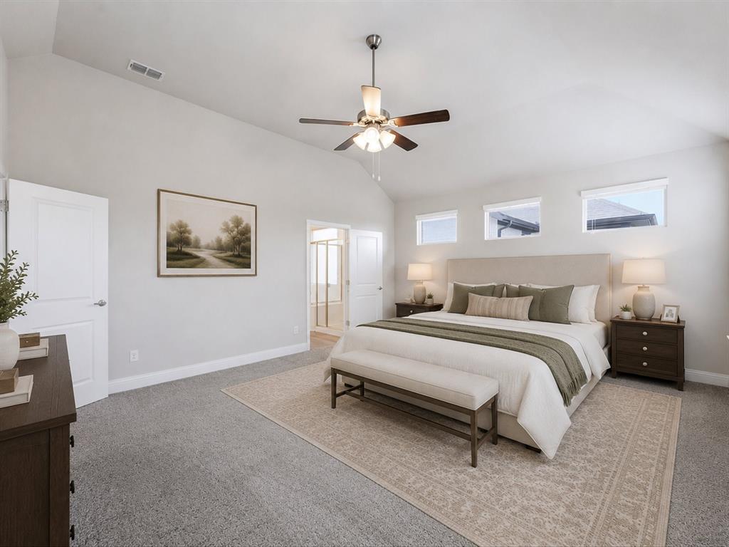 1121 Knightsbridge Road Argyle, TX 76226 - Photo 10 of 39 Virtually staged primary bedroom featuring a vaulted ceiling with a ceiling fan, plush carpet flooring, and three high-set windows