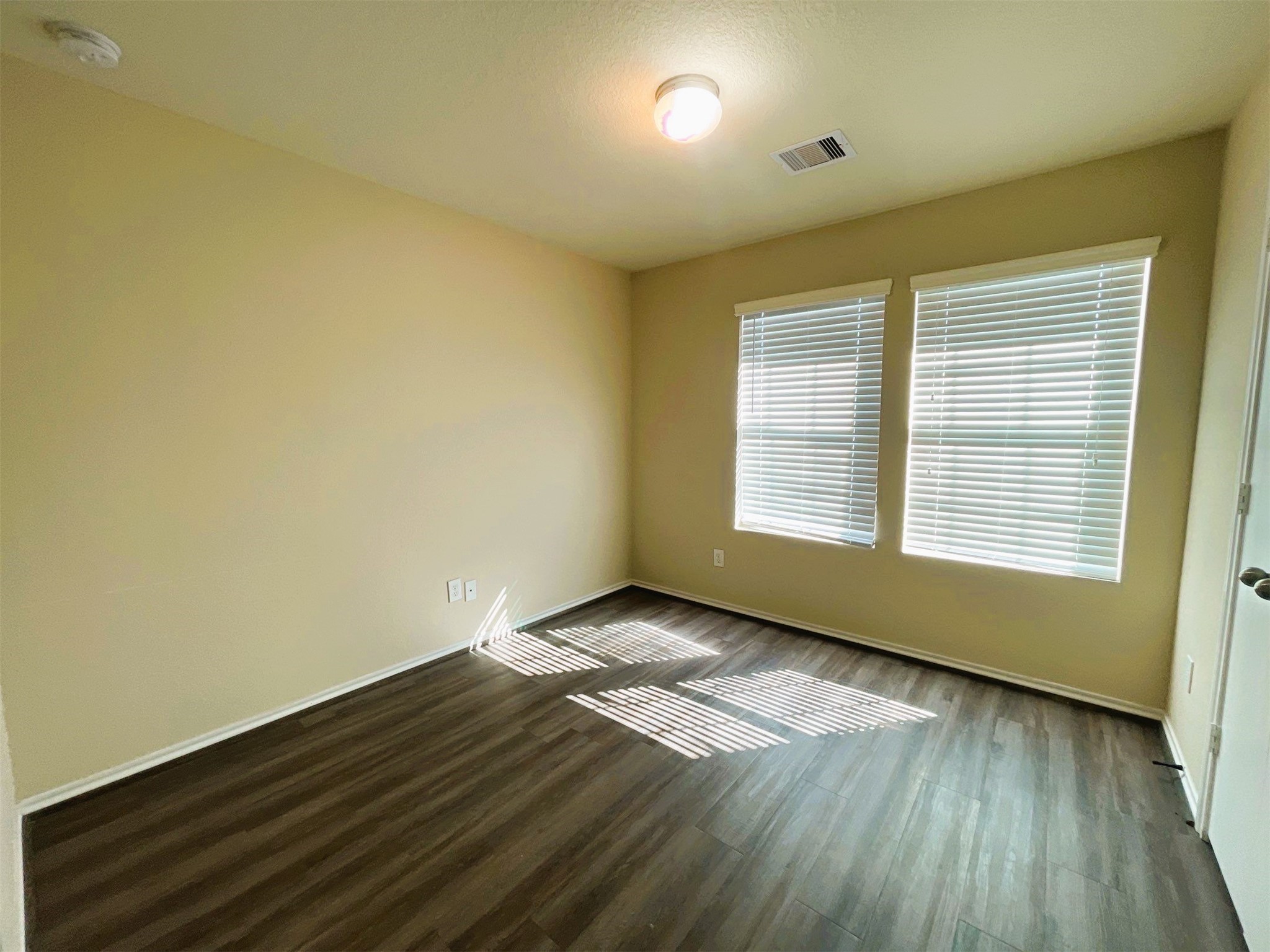 819 Katydid Court Conroe, TX 77301 - Photo 11 of 26 a view of an empty room with wooden floor and a window