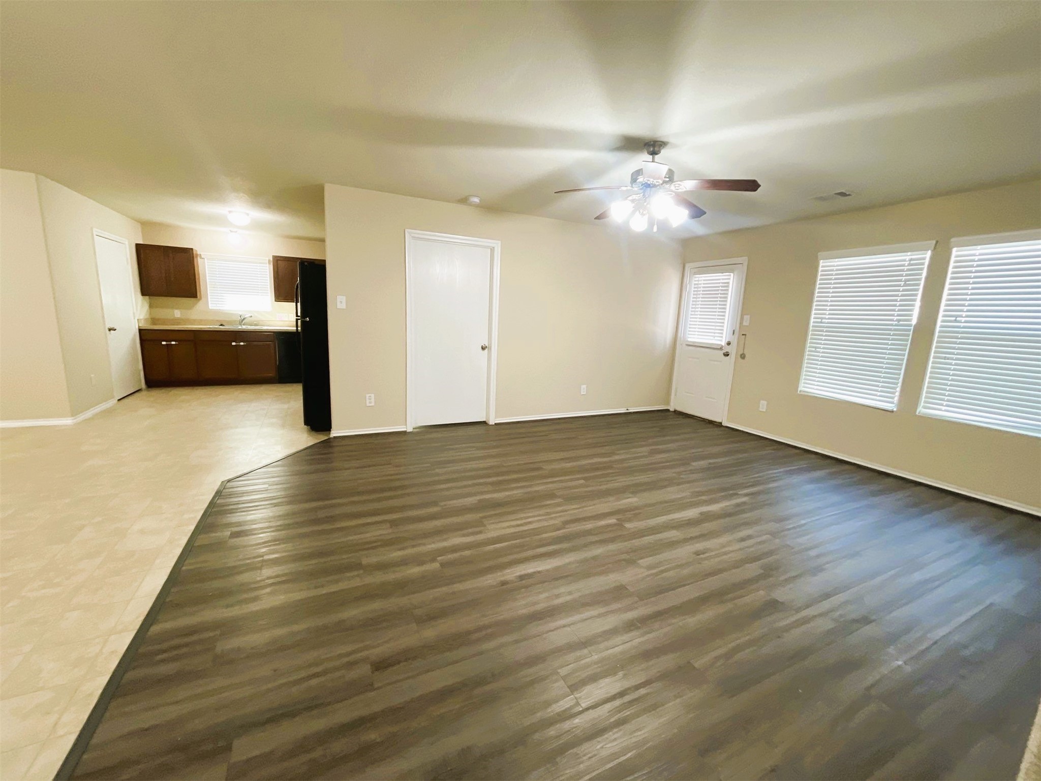 819 Katydid Court Conroe, TX 77301 - Photo 2 of 26 a view of an empty room with window and wooden floor