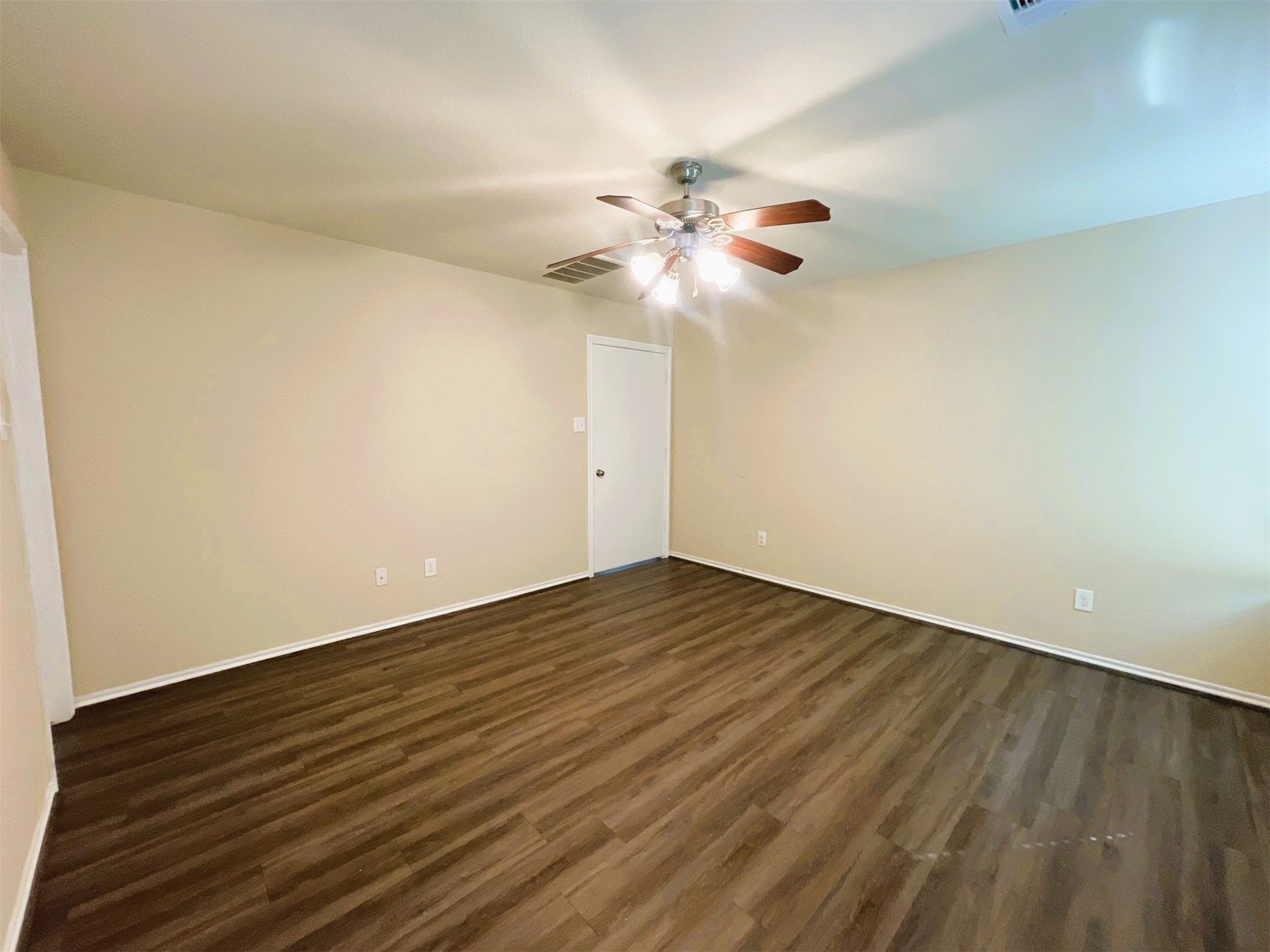 819 Katydid Court Conroe, TX 77301 - Photo 6 of 26 a view of a room with wooden floor and a ceiling fan