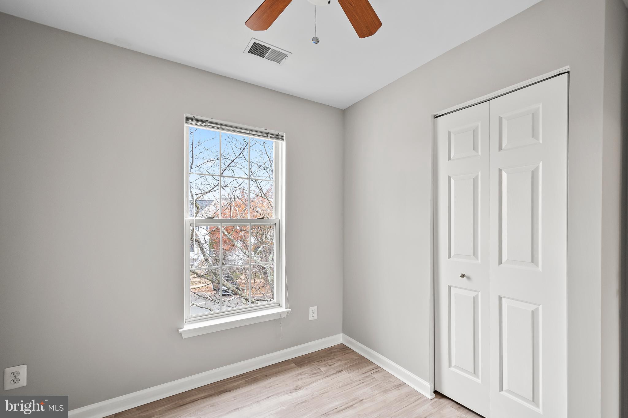 10305 Butternut Circle Manassas, VA 20110 - Photo 16 of 30 a view of an empty room with window and wooden floor