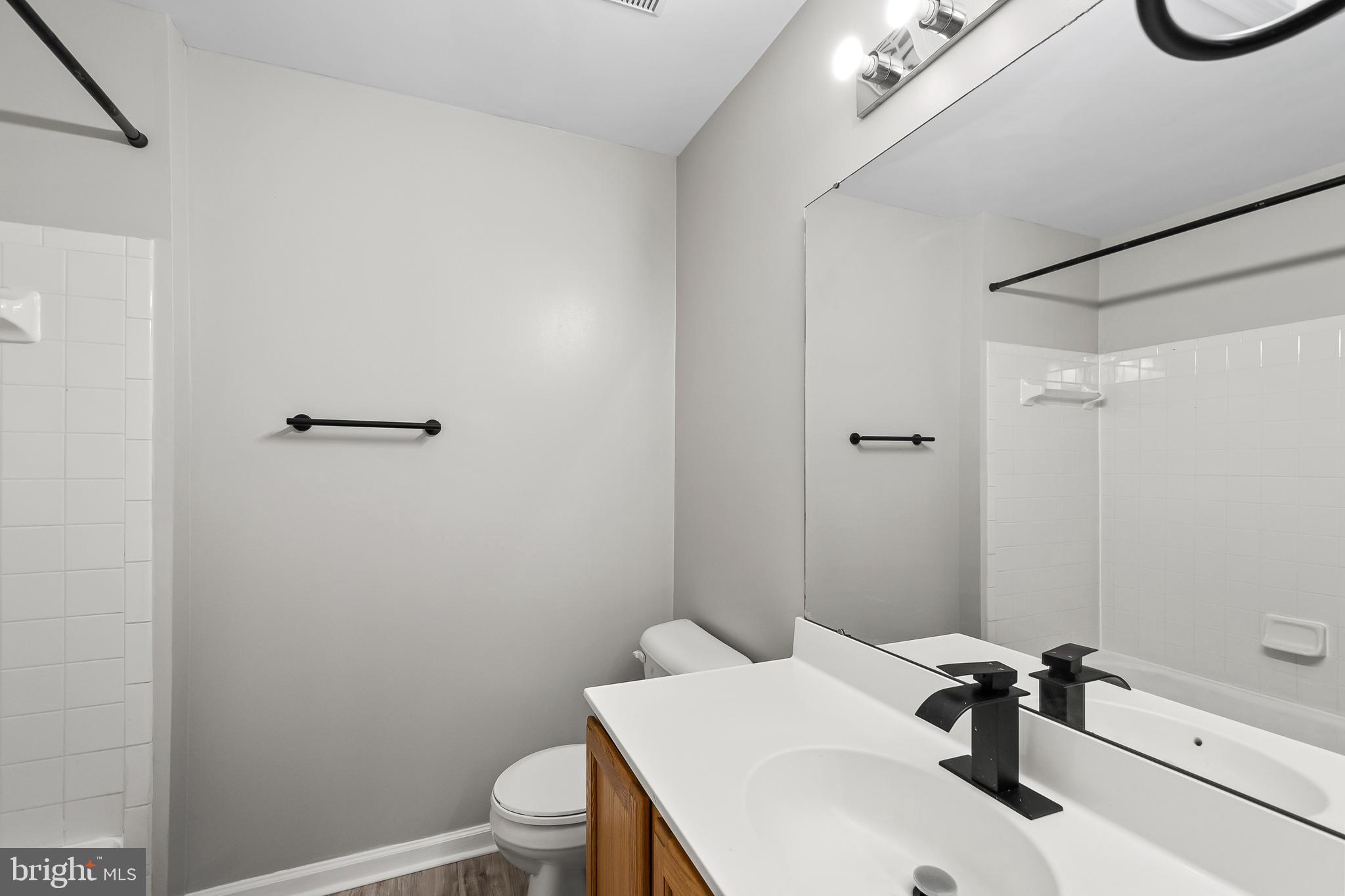 10305 Butternut Circle Manassas, VA 20110 - Photo 17 of 30 a bathroom with a sink a toilet and a mirror