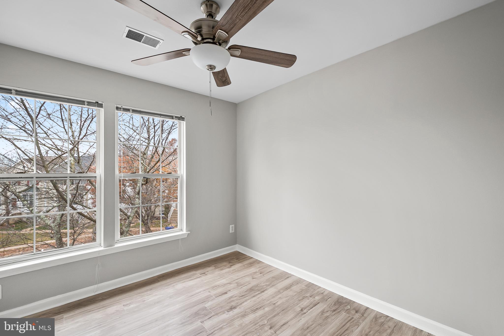 10305 Butternut Circle Manassas, VA 20110 - Photo 20 of 30 a view of an empty room with a window and wooden floor